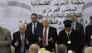 Palestinian President Mahmoud Abbas prays at the start of a meeting for the Central Council of the Palestinian Liberation Organization, in the West Bank city of Ramallah