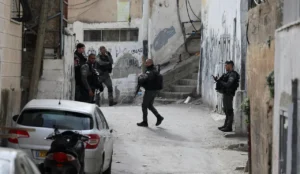 Police forces in A-Tur, outside the home of the assailant behind the attack in Neveh Yaakov, Sunday.